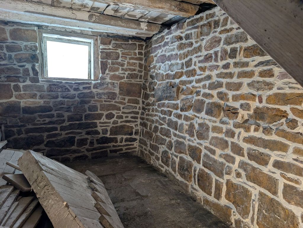 Same barn foundation with cleaned, repointed stonework after repair