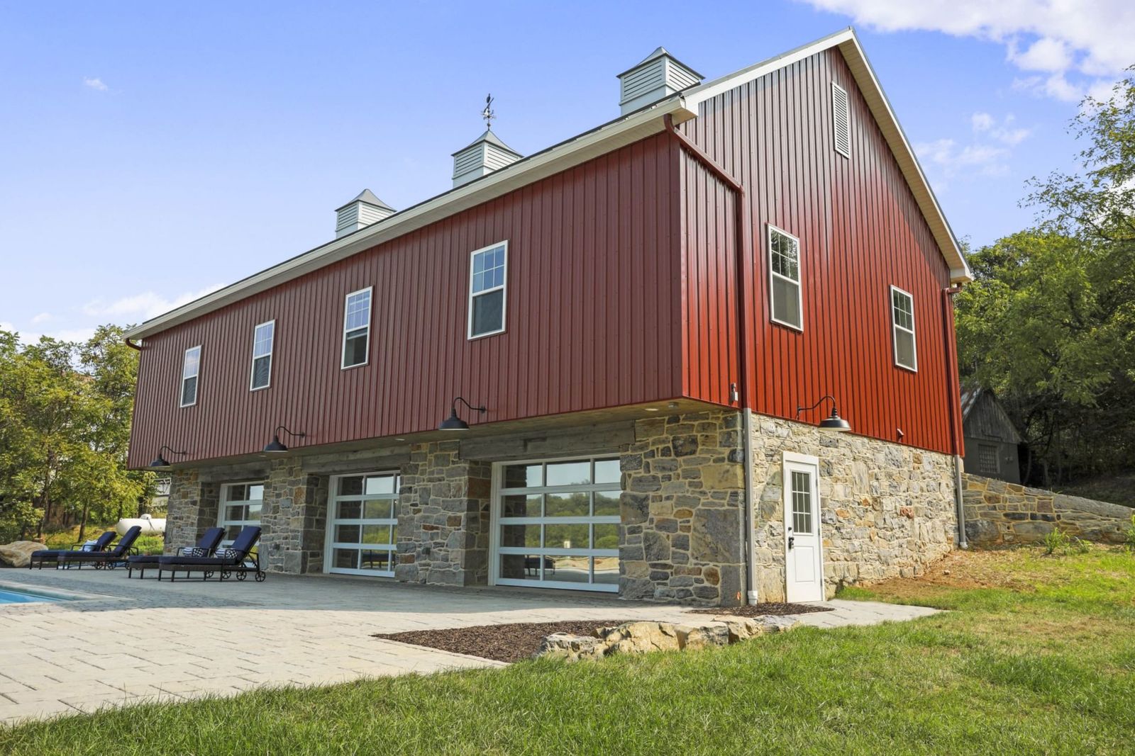 Historic red barn with stone foundation in rural Pennsylvania countryside