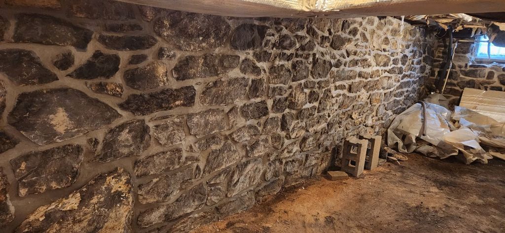Historic stone cellar foundation restored by Poor Boys' Enterprises