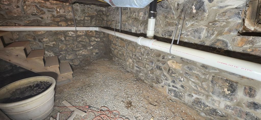 Sturdy historic stone foundation wall restored by Poor Boys' Enterprises
