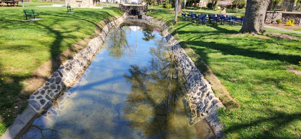 Hand-laid historic stone masonry along a restored waterway