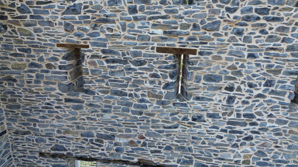 Weathered lime mortar joints that self-heal over time